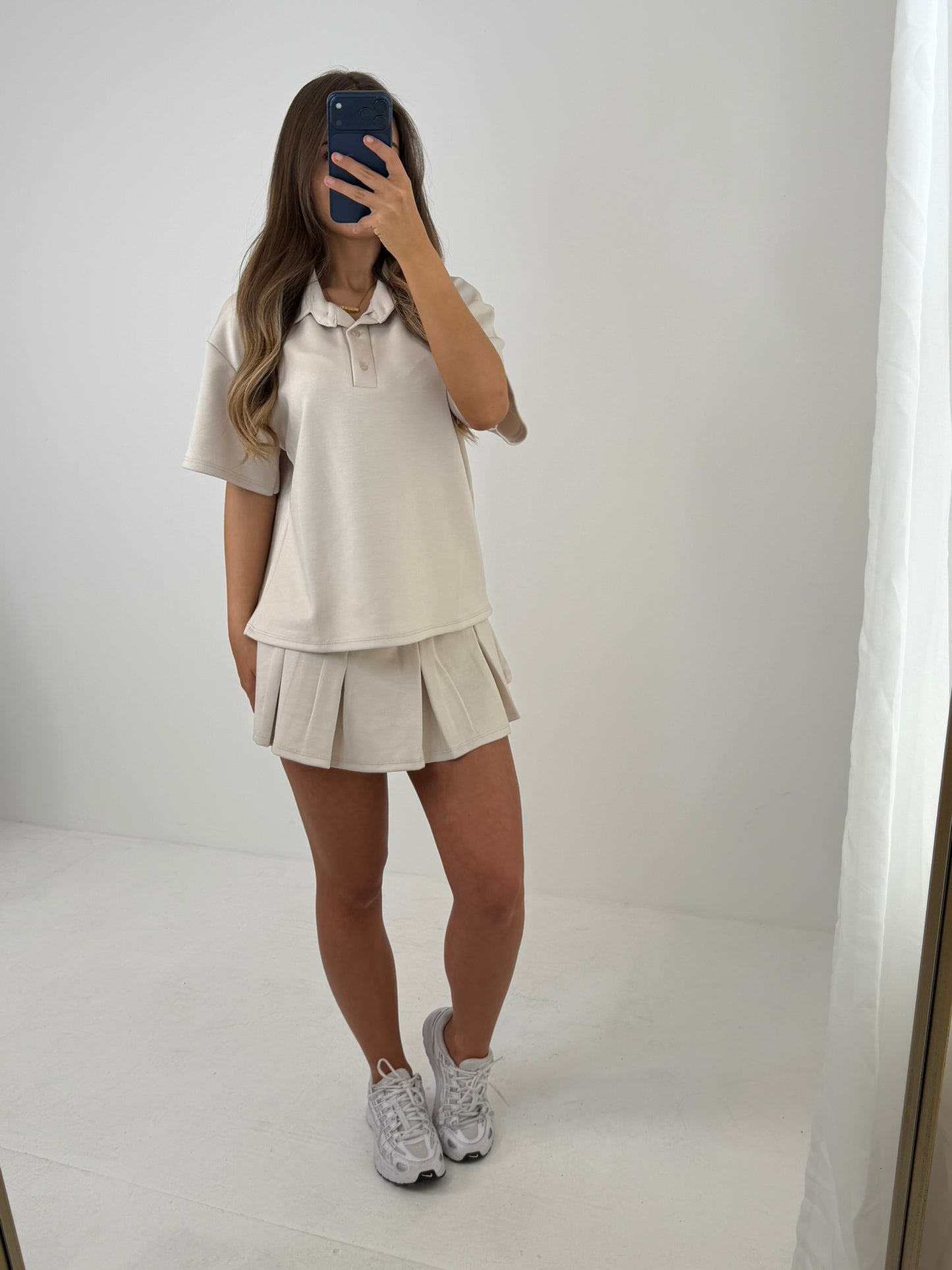 Polo buttoned short sleeved top with pleated skirt outfit