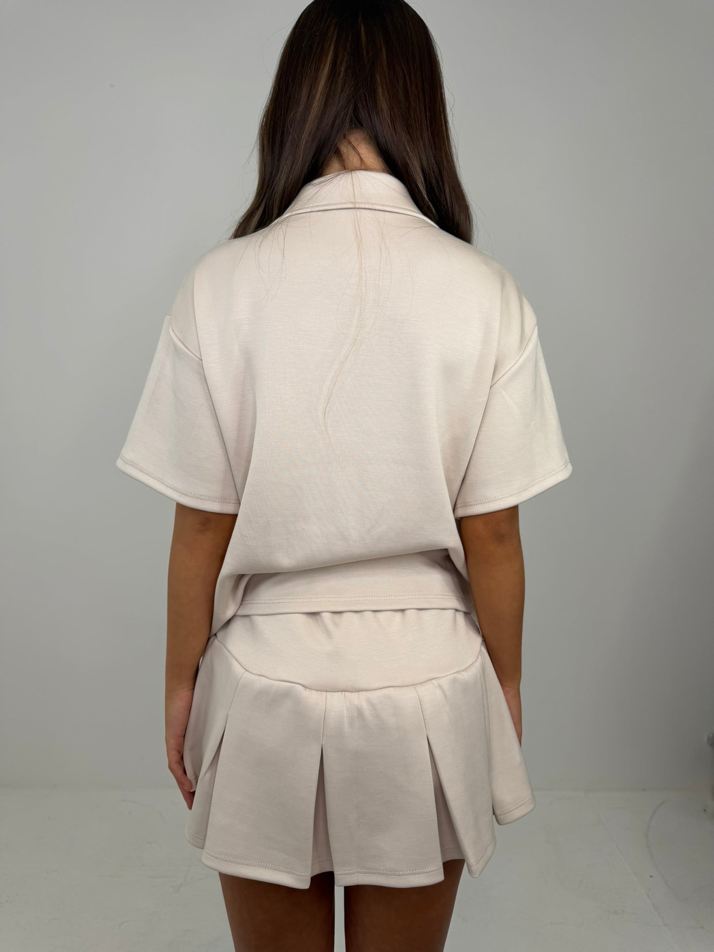 Polo buttoned short sleeved top with pleated skirt outfit