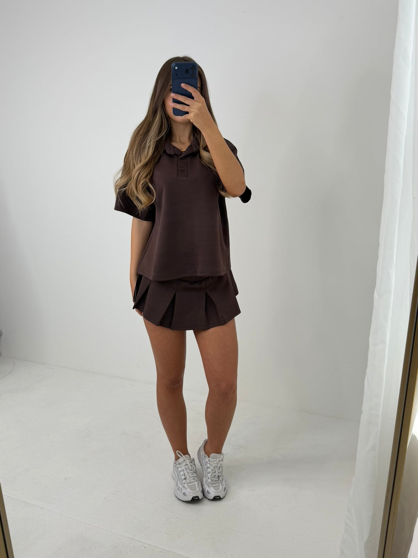 Polo buttoned short sleeved top with pleated skirt outfit