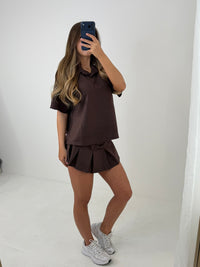 Polo buttoned short sleeved top with pleated skirt outfit