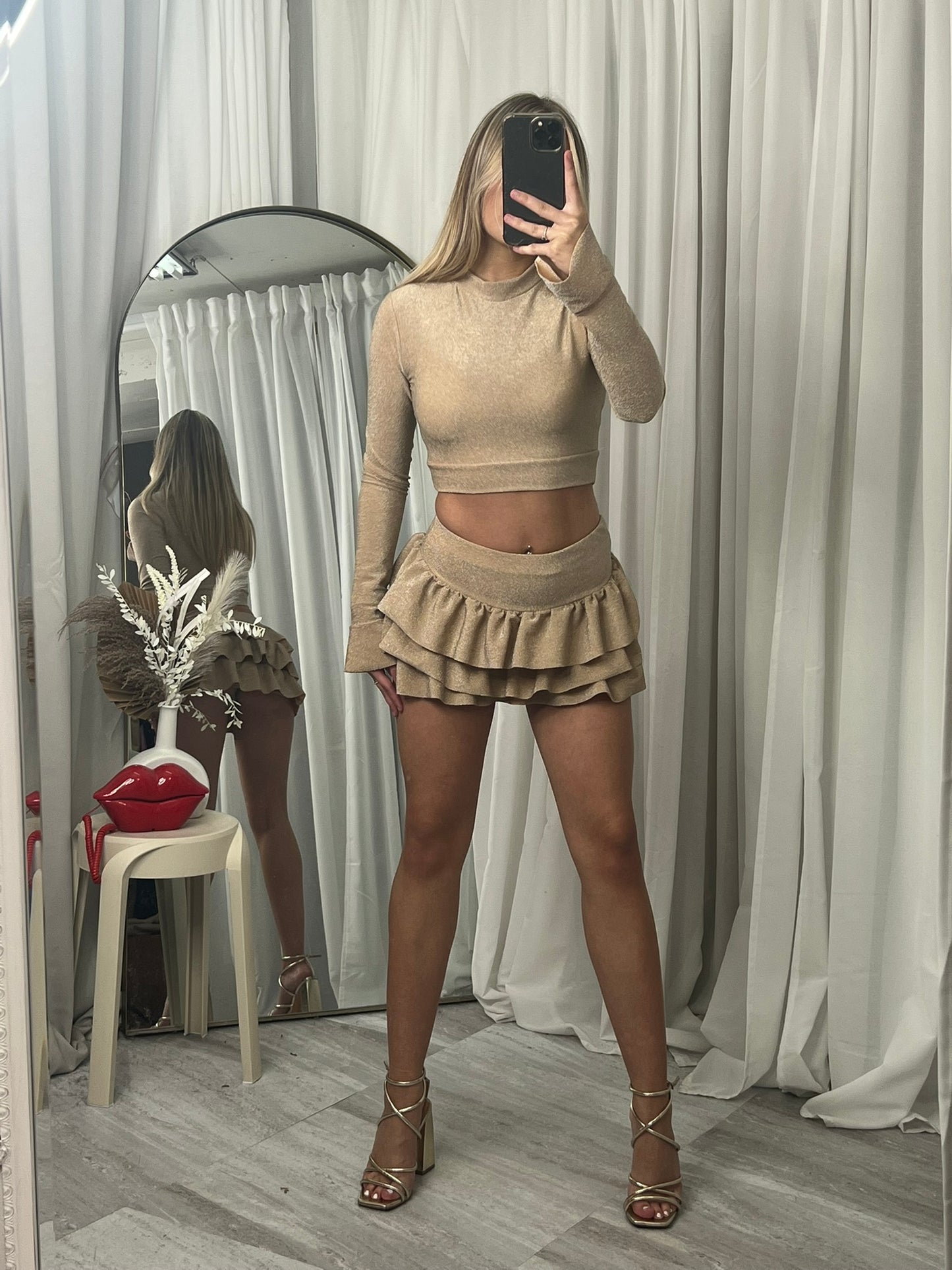 Long sleeved crop top and frill detail mini skirt party outfit
