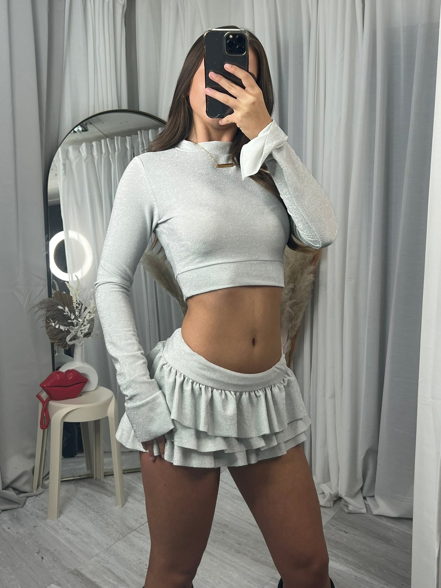 Long sleeved crop top and frill detail mini skirt party outfit