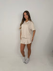 Polo buttoned short sleeved top with pleated skirt outfit
