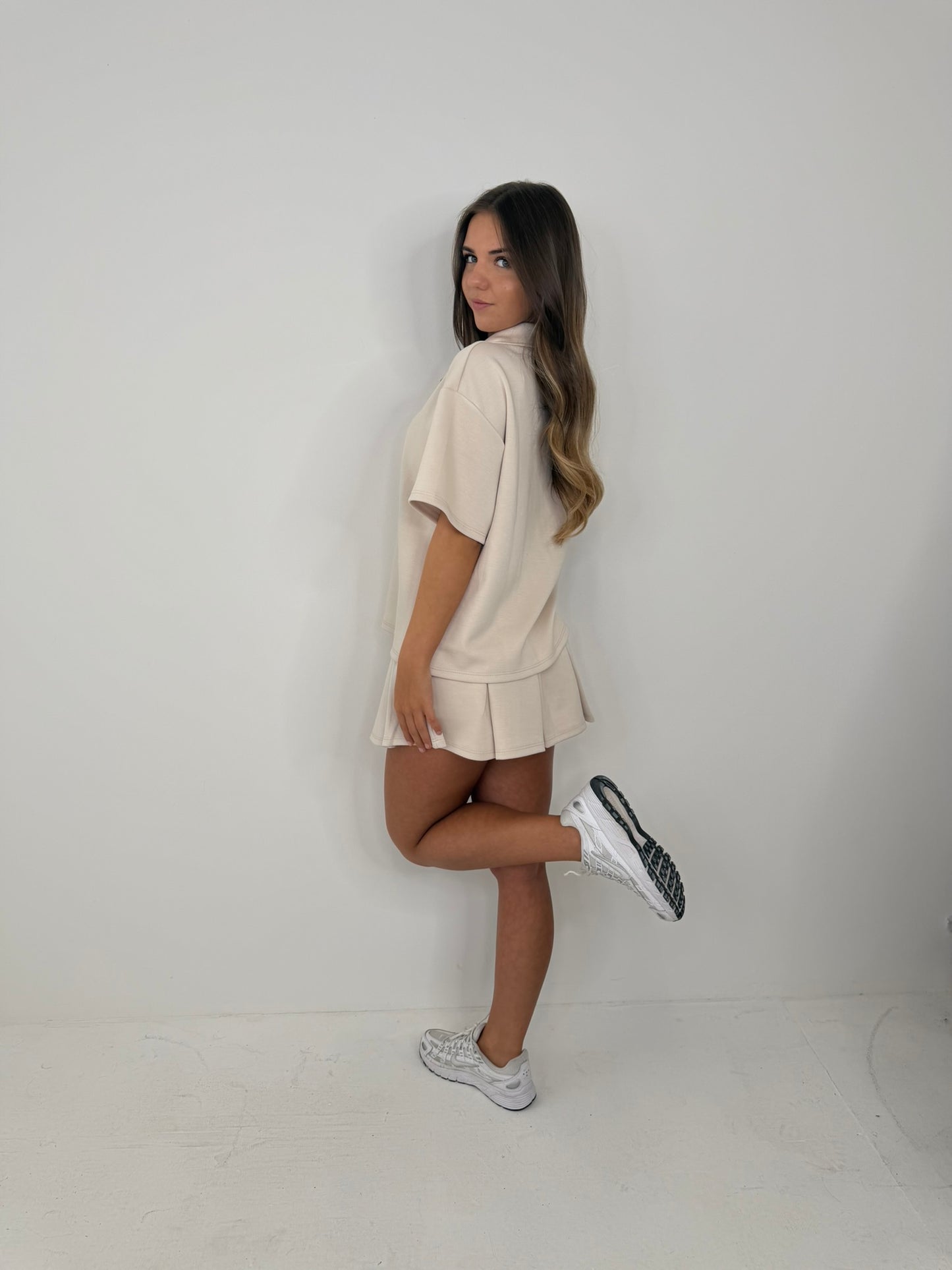 Polo buttoned short sleeved top with pleated skirt outfit