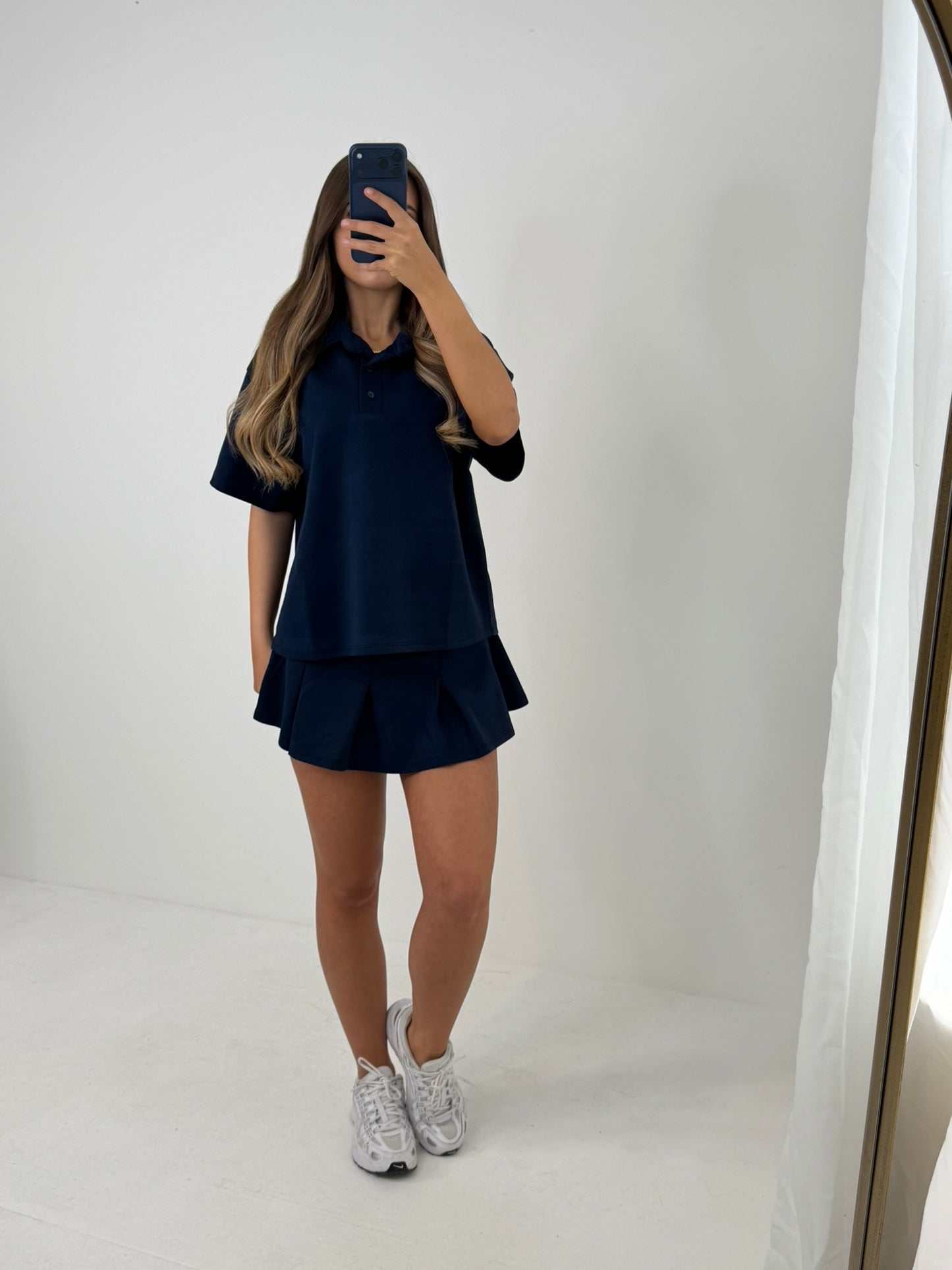 Polo buttoned short sleeved top with pleated skirt outfit