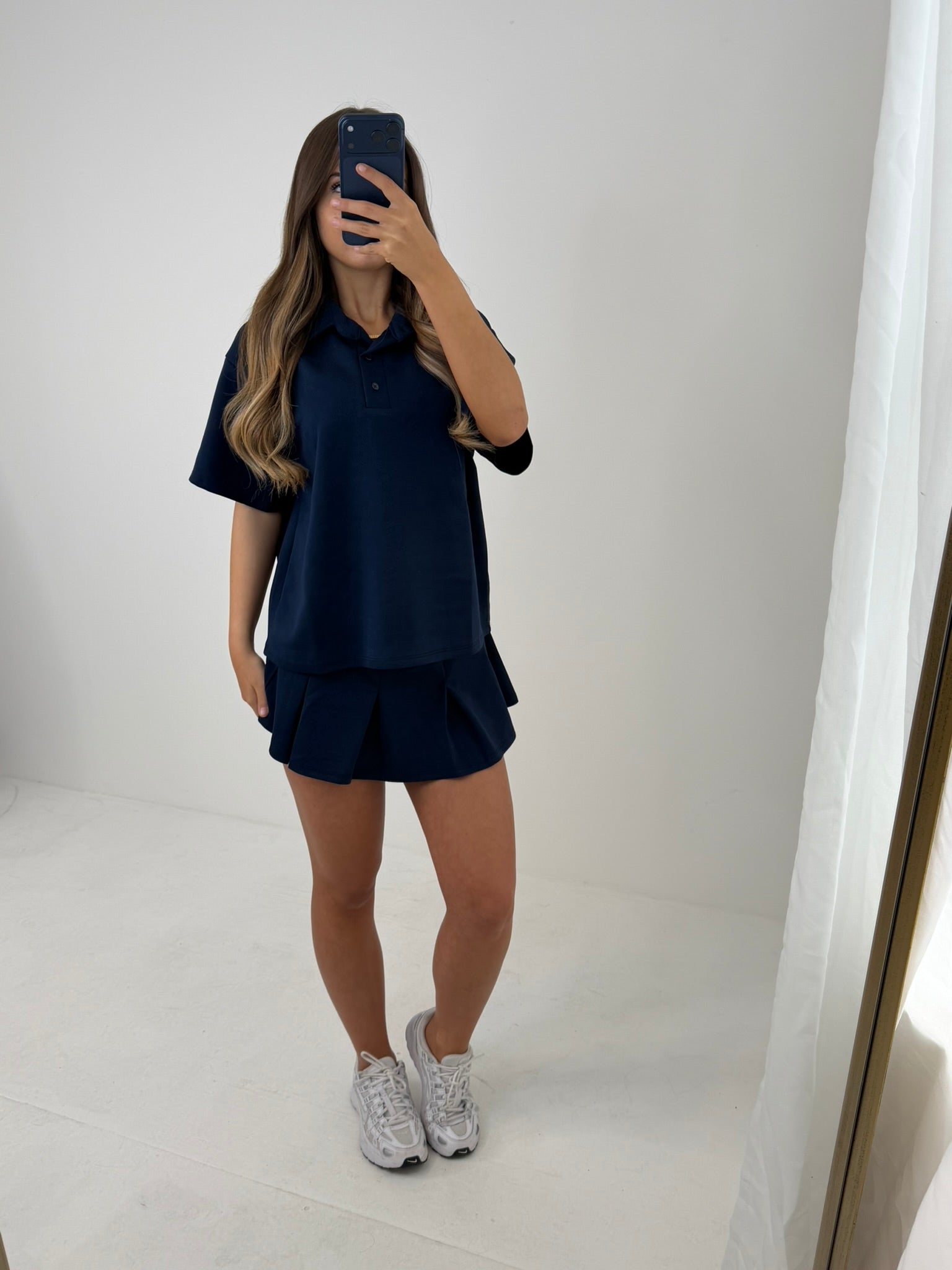 Polo buttoned short sleeved top with pleated skirt outfit