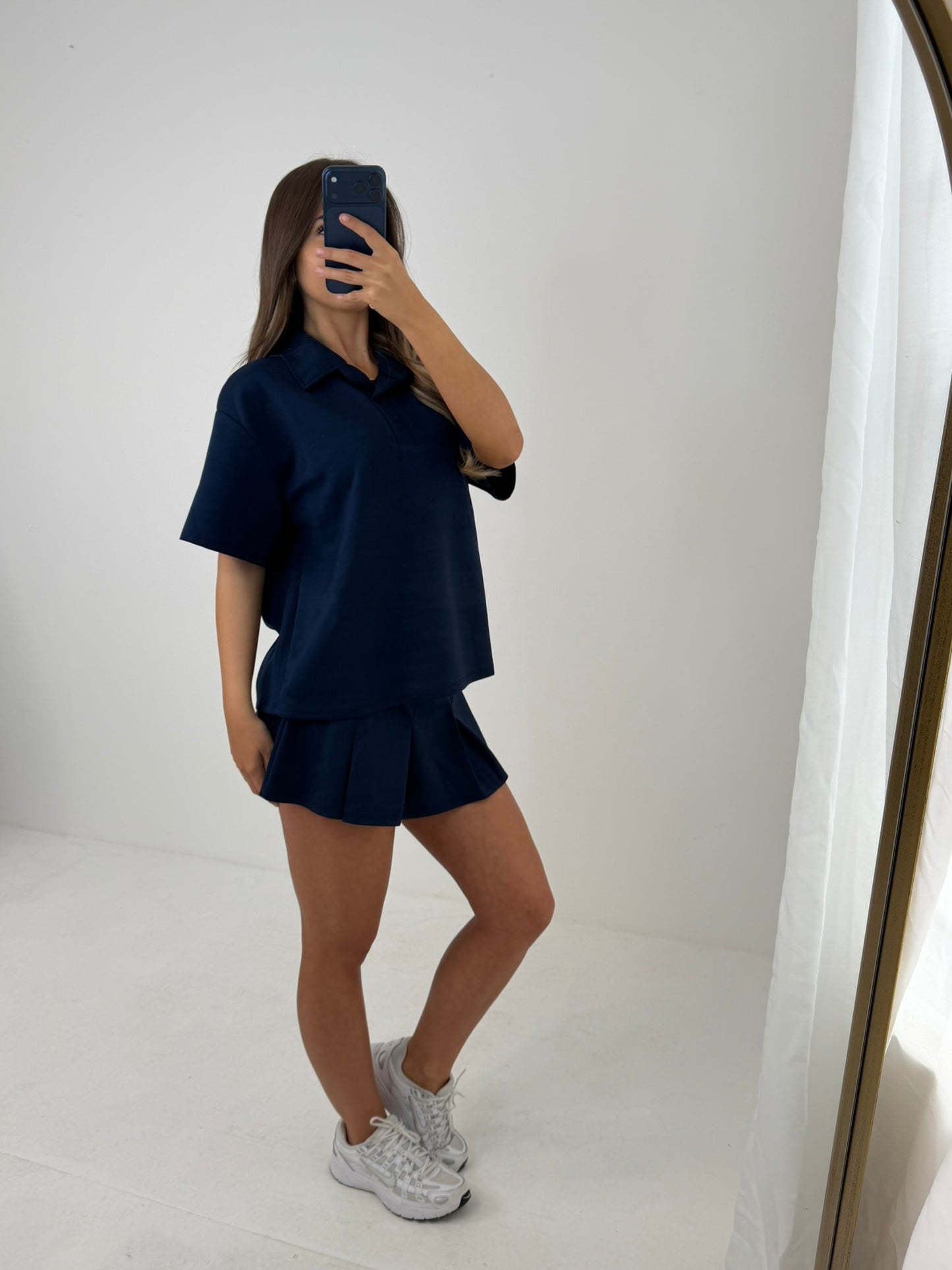 Polo buttoned short sleeved top with pleated skirt outfit