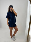 Polo buttoned short sleeved top with pleated skirt outfit