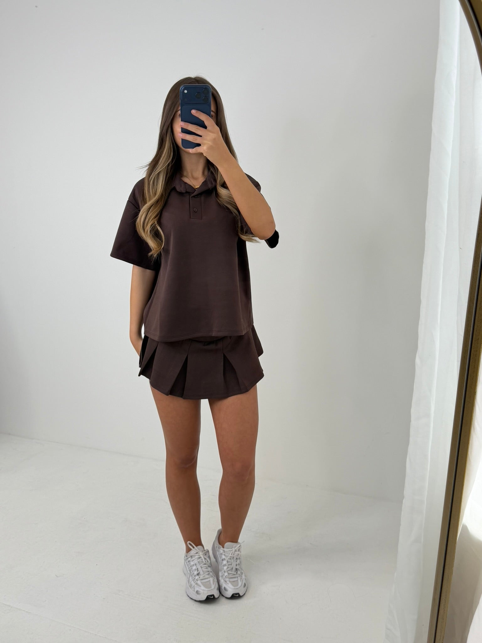 Polo buttoned short sleeved top with pleated skirt outfit