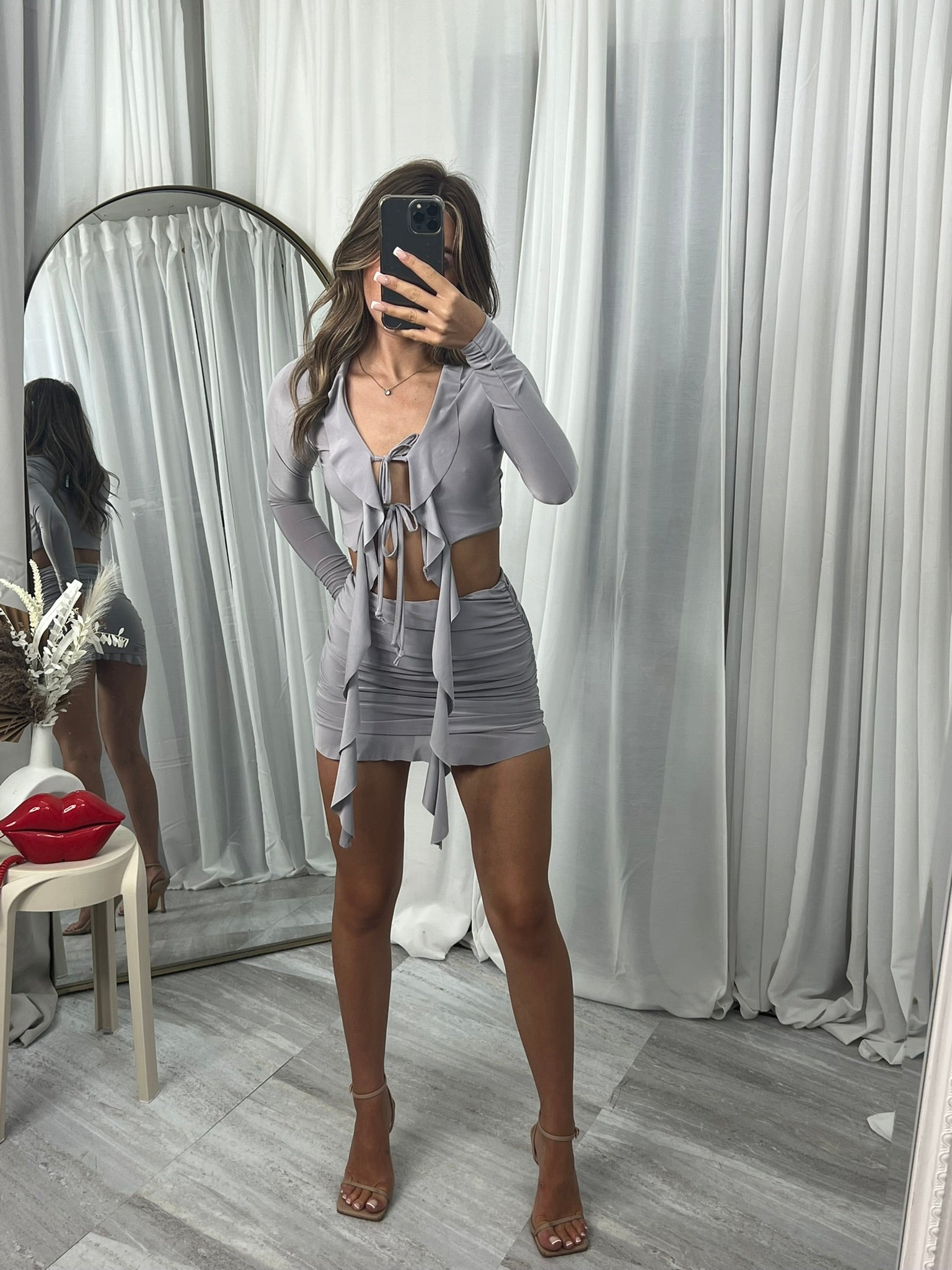 Long sleeve crop top with draped front and mini skirt