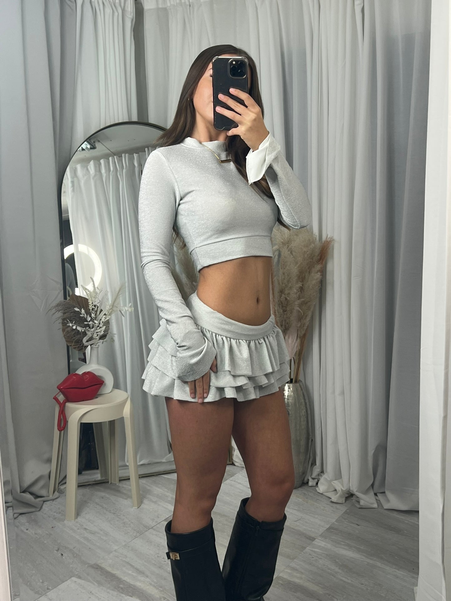 Long sleeved crop top and frill detail mini skirt party outfit